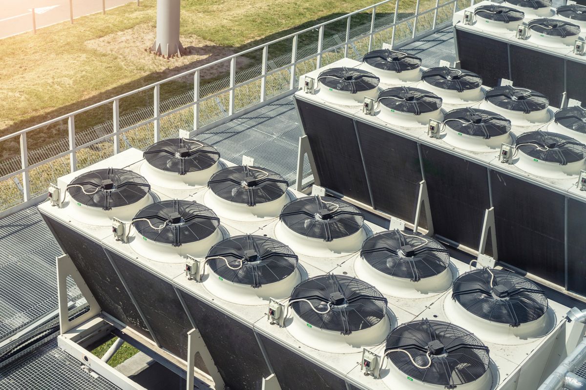 Banks of fan-driven air cooling units on an industrial site